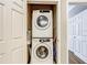 Efficient laundry closet featuring a stacked washer and dryer for space-saving convenience at 1361 Tuscan Ter # 7303, Davenport, FL 33896