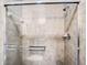 Tile shower with glass door and chrome shower head and control at 1361 Tuscan Ter # 7303, Davenport, FL 33896