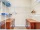 Organized walk-in closet featuring wooden drawers and ample shelving for clothing and storage solutions at 1361 Tuscan Ter # 7303, Davenport, FL 33896