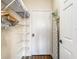 Spacious walk-in closet equipped with shelving, racks, and an ironing board for organized storage at 1361 Tuscan Ter # 7303, Davenport, FL 33896