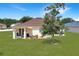 Lush backyard featuring a covered patio, garden, and well-maintained landscaping at 1405 Hillsborough Way, Kissimmee, FL 34759