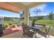 Inviting back patio with an awning, table, chairs, and a spacious yard at 1405 Hillsborough Way, Kissimmee, FL 34759