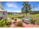 Backyard with a patio, bench, garden, and lush greenery at 1405 Hillsborough Way, Kissimmee, FL 34759
