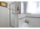 Bathroom features a tub with a shower and decorative wall tiles at 1405 Hillsborough Way, Kissimmee, FL 34759