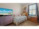 Bedroom featuring a twin bed, lilac dresser, and entertainment center at 1405 Hillsborough Way, Kissimmee, FL 34759