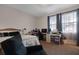 Bedroom features a queen bed, a desk, and a lounge chair at 1405 Hillsborough Way, Kissimmee, FL 34759