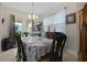 Dining room featuring tile floors, a large window, and an ornate wooden table with six chairs at 1405 Hillsborough Way, Kissimmee, FL 34759