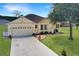 Charming single-story home with a two-car garage, manicured lawn, and lovely landscaping at 1405 Hillsborough Way, Kissimmee, FL 34759