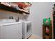 Well-equipped laundry room with washer, dryer, and ample shelving at 1405 Hillsborough Way, Kissimmee, FL 34759
