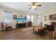Comfortable living room featuring hardwood floors, natural light, and a decorative chair at 1405 Hillsborough Way, Kissimmee, FL 34759
