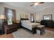 Spacious main bedroom with tray ceilings, sitting area, and a king-size bed at 1405 Hillsborough Way, Kissimmee, FL 34759
