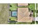 Aerial shot of a private pool and patio, screened for comfort, in a verdant, landscaped yard at 1452 Mickelson Ct, Davenport, FL 33896