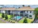 Aerial view of a screened-in pool, situated in a beautifully landscaped backyard setting at 1452 Mickelson Ct, Davenport, FL 33896
