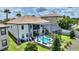 Aerial view of a home with a screened-in pool and a well-maintained backyard at 1452 Mickelson Ct, Davenport, FL 33896