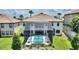 Aerial view of a home and screened-in pool, surrounded by well-manicured landscaping at 1452 Mickelson Ct, Davenport, FL 33896