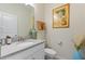 Well-lit half bathroom featuring contemporary fixtures and stylish decor at 1452 Mickelson Ct, Davenport, FL 33896