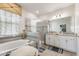 Luxurious bathroom featuring a soaking tub, a separate glass-enclosed shower, and dual vanities at 1452 Mickelson Ct, Davenport, FL 33896