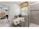 Elegant bathroom with a soaking tub, a walk-in shower with grey tile, and a view to the main bedroom at 1452 Mickelson Ct, Davenport, FL 33896