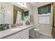 This bathroom has a sink, toilet, and a large framed mirror at 1452 Mickelson Ct, Davenport, FL 33896