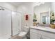 Modern bathroom featuring a glass-enclosed shower, white vanity, and neutral decor at 1452 Mickelson Ct, Davenport, FL 33896