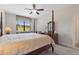 Bright bedroom showcasing a four-poster bed and a large window with views at 1452 Mickelson Ct, Davenport, FL 33896