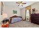 Cozy bedroom with a daybed, warm lighting, and a view of the outdoor landscape at 1452 Mickelson Ct, Davenport, FL 33896