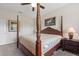 Bedroom with traditional four-poster bed, neutral walls, carpet, and ceiling fan at 1452 Mickelson Ct, Davenport, FL 33896
