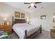 Well-lit bedroom with a four-poster bed, a ceiling fan, and ample natural light at 1452 Mickelson Ct, Davenport, FL 33896