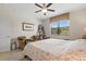 Cozy bedroom featuring a large window, carpet flooring and comfortable seating at 1452 Mickelson Ct, Davenport, FL 33896