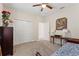 This bedroom has a ceiling fan, closet, and a wooden table at 1452 Mickelson Ct, Davenport, FL 33896