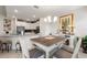 Inviting dining area open to the kitchen, featuring a farmhouse table and a cozy fireplace at 1452 Mickelson Ct, Davenport, FL 33896