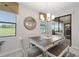 Charming dining area with natural light, a stylish chandelier, and sliding glass doors leading to a patio at 1452 Mickelson Ct, Davenport, FL 33896