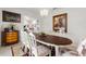 Formal dining room with stylish chairs, an oval table, and chandelier. Connected to another living area at 1452 Mickelson Ct, Davenport, FL 33896