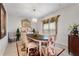 Formal dining room featuring stylish chairs, decorative window treatments, and a chandelier at 1452 Mickelson Ct, Davenport, FL 33896