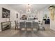 This dining room has a chandelier and a large glass dining table at 1452 Mickelson Ct, Davenport, FL 33896