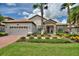 Beautiful single Gathering home featuring a tile roof, a two-car garage, and well-maintained landscaping at 1452 Mickelson Ct, Davenport, FL 33896