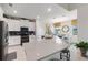 Bright kitchen with white cabinets, stainless steel appliances, and an island with bar seating at 1452 Mickelson Ct, Davenport, FL 33896