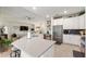 Bright, open kitchen featuring stainless steel appliances, granite countertops, and a seamless flow to the living area at 1452 Mickelson Ct, Davenport, FL 33896