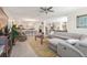 Open-concept living room with tile flooring, a large sectional sofa, and a view of the kitchen at 1452 Mickelson Ct, Davenport, FL 33896