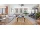 Spacious living room with a large sectional sofa, decorative rug, and modern ceiling fan at 1452 Mickelson Ct, Davenport, FL 33896