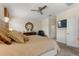 Comfortable main bedroom with a ceiling fan, and an ornate mirror above a wooden dresser at 1452 Mickelson Ct, Davenport, FL 33896