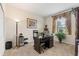 The office has a large wooden desk, a lamp, and a plant at 1452 Mickelson Ct, Davenport, FL 33896