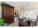 The office has a large wooden desk, a lamp, and a bookshelf at 1452 Mickelson Ct, Davenport, FL 33896