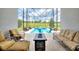 Beautiful screened-in pool and patio area featuring comfortable seating and views of lush landscaping at 1452 Mickelson Ct, Davenport, FL 33896