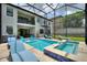Screen enclosed pool area with a pool, jacuzzi, and lounge chairs, with a home exterior in the background at 1452 Mickelson Ct, Davenport, FL 33896