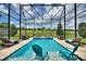 Sparkling pool with sun loungers and lush greenery, perfect for relaxation at 1452 Mickelson Ct, Davenport, FL 33896