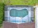 Aerial view of screened pool with unique shape, attached sunroom, and privacy fence at 1515 Oak Hill Trl, Kissimmee, FL 34747