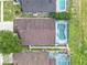 Aerial view of homes, showing roof condition, pool enclosures, yards, and neighborhood at 1515 Oak Hill Trl, Kissimmee, FL 34747