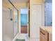 Bright bathroom with tile shower, granite countertop vanity, and access to closet and bedroom at 1515 Oak Hill Trl, Kissimmee, FL 34747