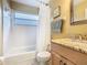 Bathroom featuring a vanity, a toilet, and a shower and tub with a curtain at 1515 Oak Hill Trl, Kissimmee, FL 34747